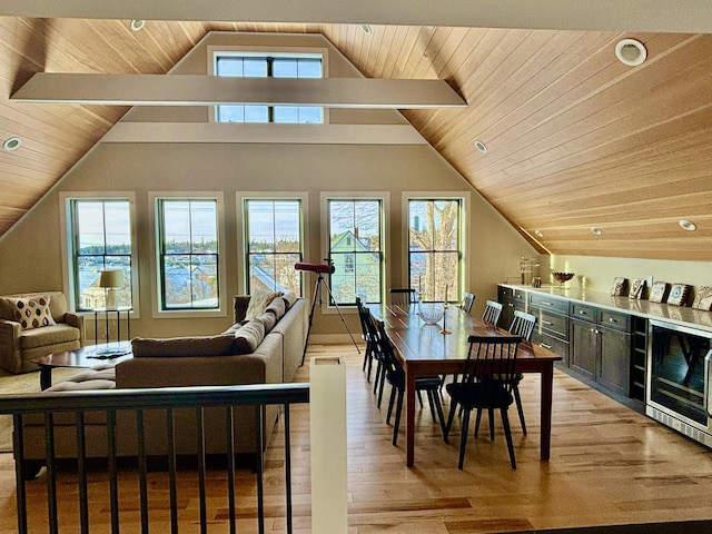 dining area with wine cooler, light hardwood / wood-style flooring, and a wealth of natural light