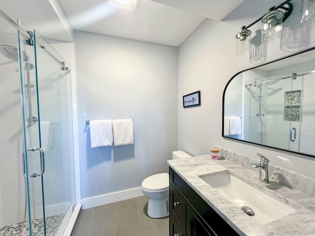 bathroom with vanity, toilet, and an enclosed shower