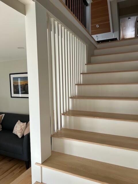 stairway with wood finished floors
