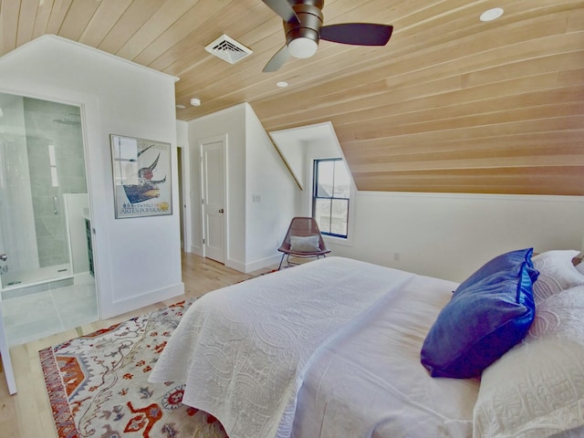 bedroom featuring wood ceiling, vaulted ceiling, visible vents, and connected bathroom