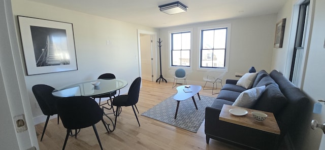 living room featuring light wood finished floors and baseboards