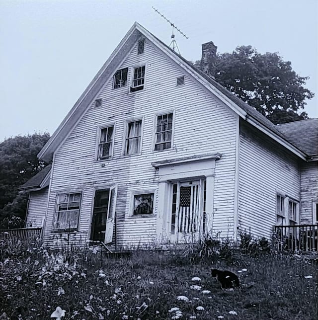 view of front of home featuring a chimney