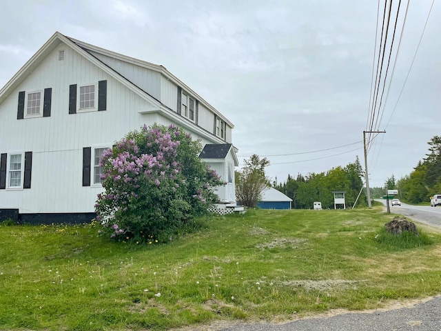 view of side of property with a yard