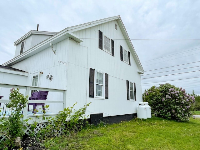 view of property exterior featuring a lawn