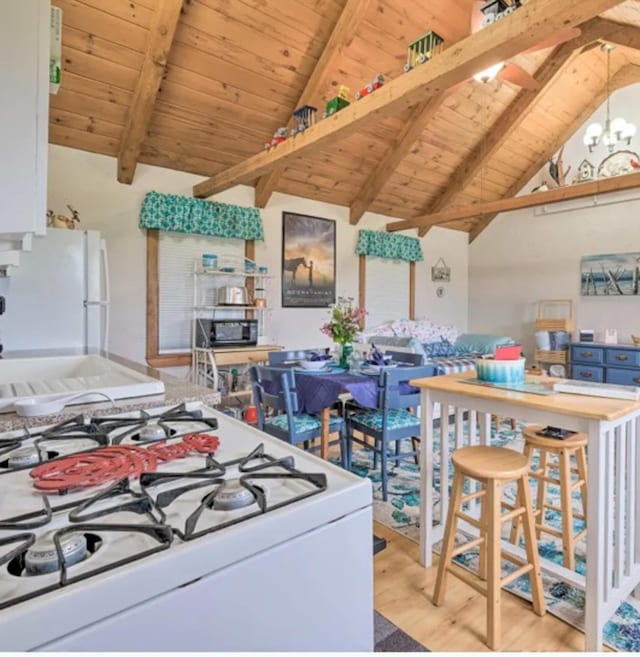 kitchen featuring white appliances, wood ceiling, light hardwood / wood-style floors, lofted ceiling with beams, and a chandelier