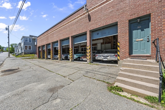 entrance to property featuring brick siding