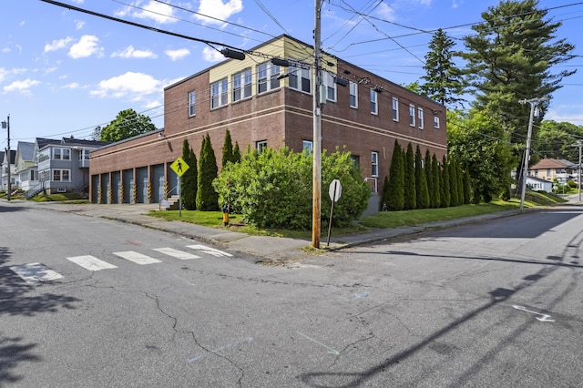 view of building exterior featuring community garages