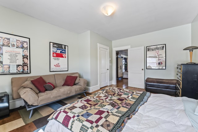 bedroom featuring baseboards and wood finished floors