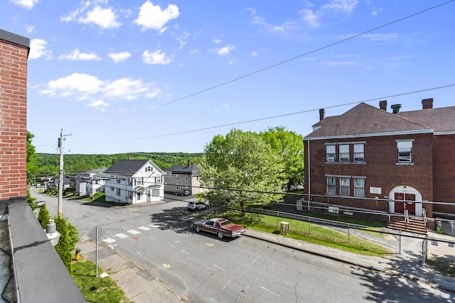 exterior space featuring sidewalks, curbs, and a residential view
