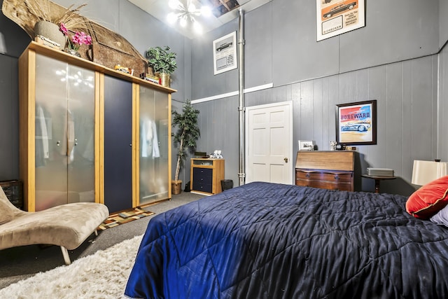 bedroom with a high ceiling and carpet