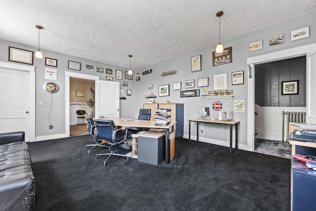home office with baseboards, a textured ceiling, dark carpet, and radiator heating unit