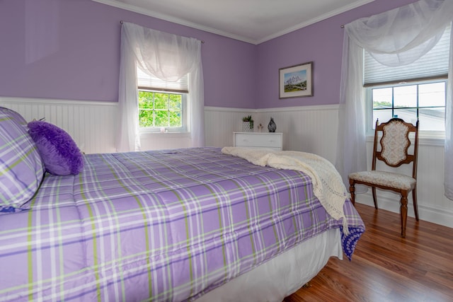 bedroom with hardwood / wood-style floors and ornamental molding