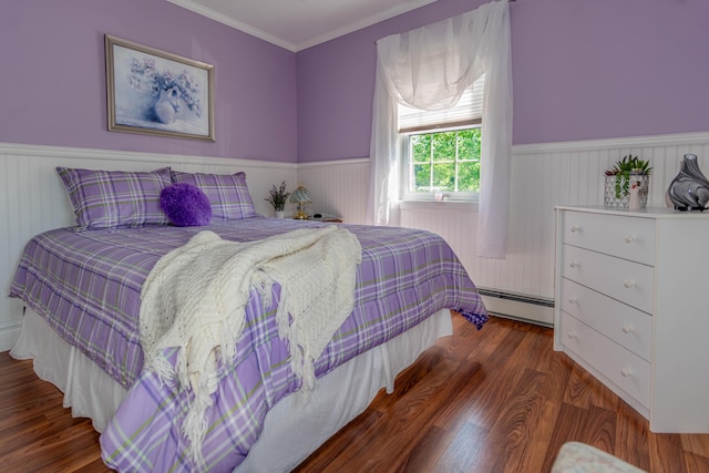 bedroom featuring dark wood-type flooring, a baseboard heating unit, and ornamental molding