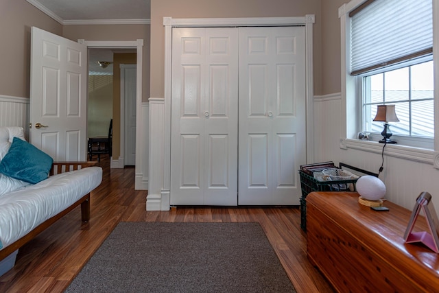 bedroom with a closet, ornamental molding, and dark hardwood / wood-style floors