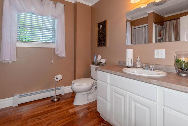 bathroom with toilet, hardwood / wood-style floors, a baseboard heating unit, crown molding, and vanity