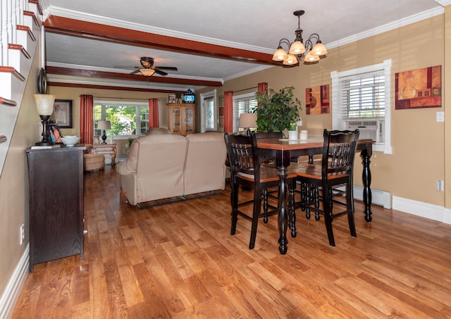 dining room with a healthy amount of sunlight, crown molding, ceiling fan with notable chandelier, and light hardwood / wood-style floors