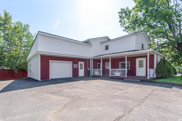 view of front of house featuring a porch and a garage