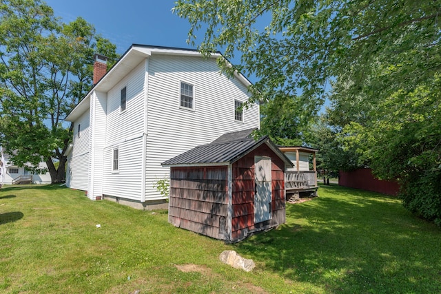 exterior space with a lawn and a storage shed