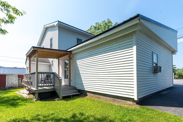 rear view of property featuring a yard