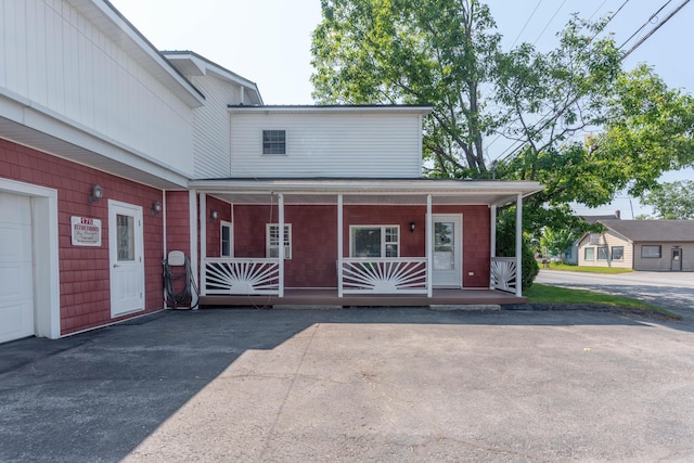 view of front of property with a porch and a garage