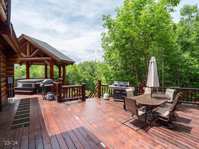 wooden terrace featuring a hot tub and grilling area