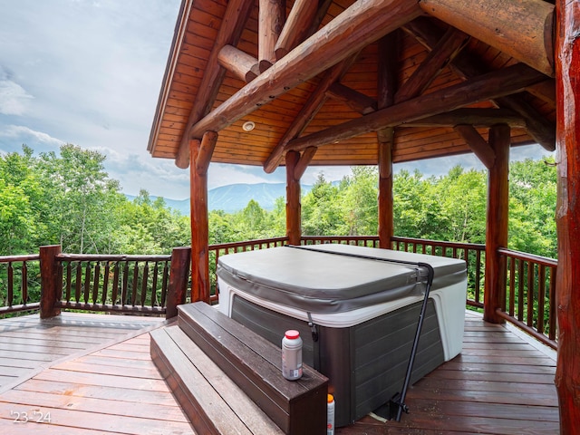 wooden terrace with a mountain view and a hot tub