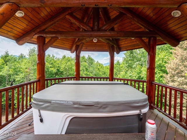 wooden deck featuring a hot tub