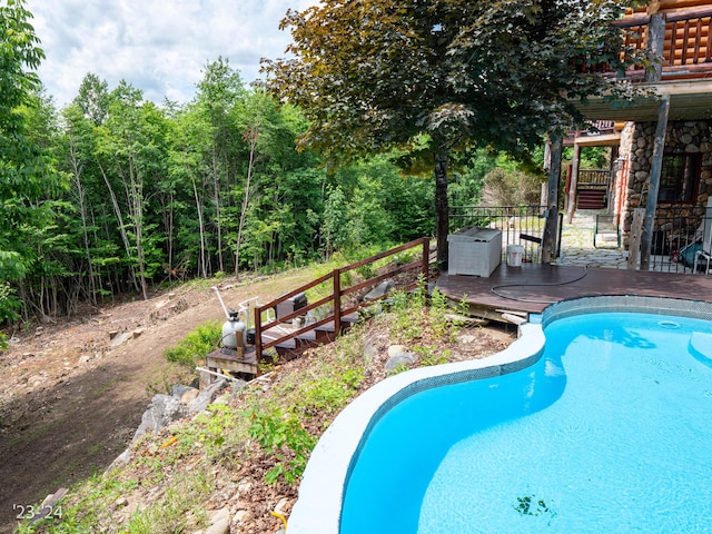 view of swimming pool featuring a wooden deck