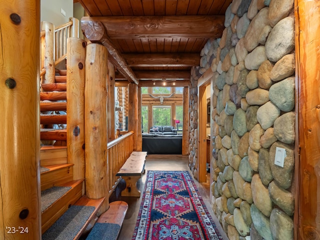 corridor with tile patterned floors, beam ceiling, and wooden ceiling