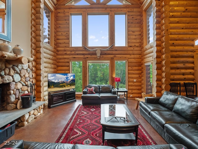 living room featuring a high ceiling, a stone fireplace, and rustic walls