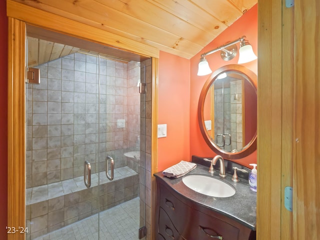 bathroom featuring lofted ceiling, vanity, wooden ceiling, and a shower with shower door