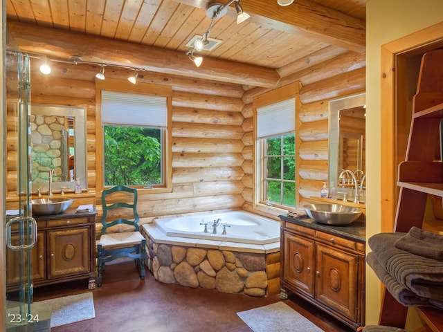 bathroom featuring beamed ceiling, a bath, vanity, and rustic walls