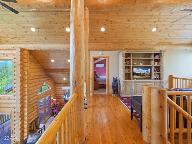 corridor with high vaulted ceiling, light wood-type flooring, wood ceiling, and log walls