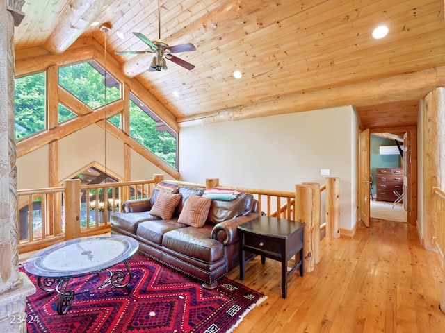 living room featuring ceiling fan, plenty of natural light, wooden ceiling, and light wood-type flooring