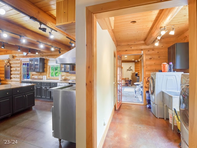 kitchen featuring log walls, washing machine and dryer, and wooden ceiling