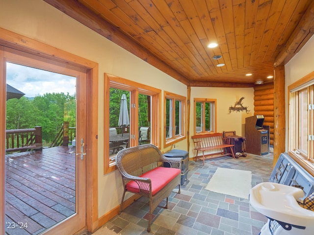 sunroom / solarium with lofted ceiling and wooden ceiling