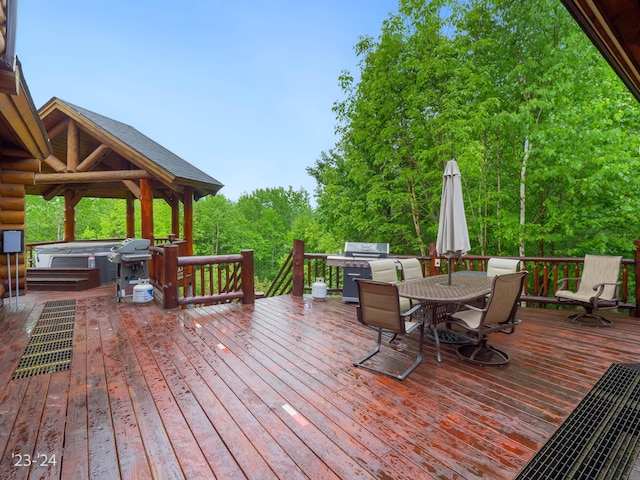 wooden deck featuring a hot tub and grilling area