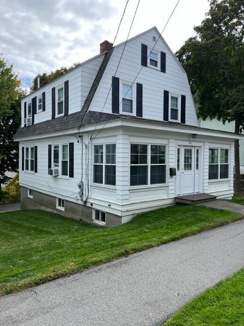 view of front of home featuring a front lawn and cooling unit