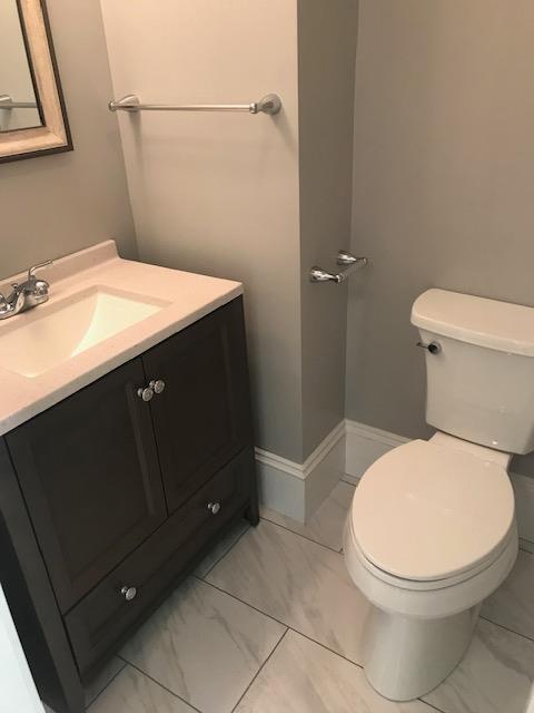 bathroom featuring toilet and vanity