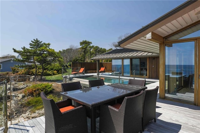 wooden terrace featuring a fenced in pool