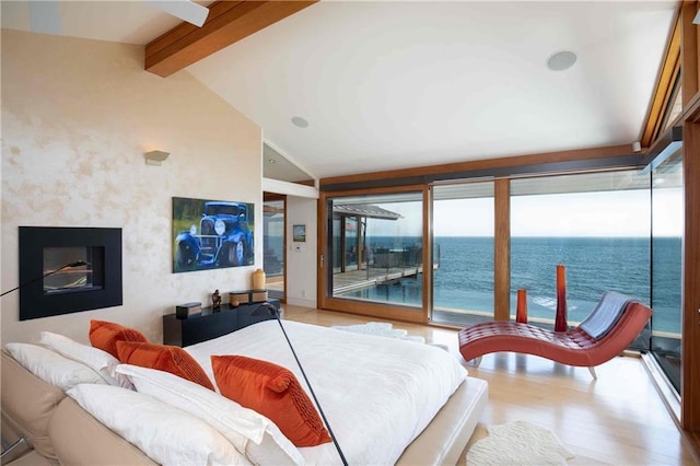 bedroom featuring a water view, vaulted ceiling with beams, access to outside, and light hardwood / wood-style flooring
