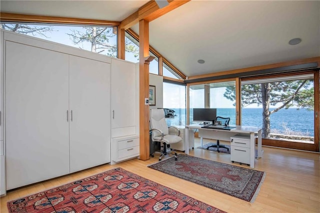 office featuring light wood-type flooring and vaulted ceiling with beams