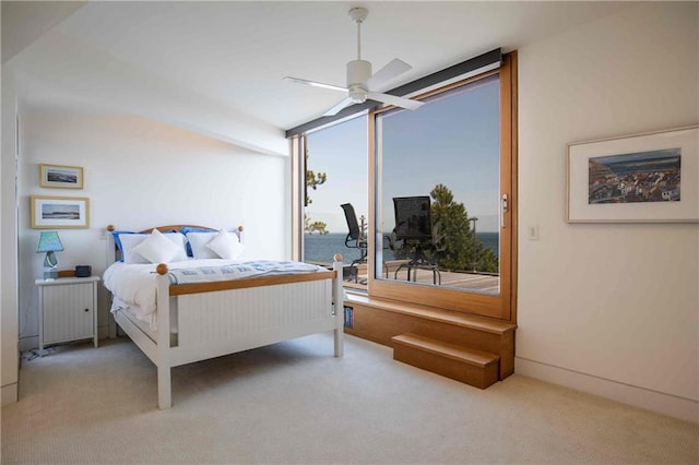 bedroom with a water view, ceiling fan, and carpet flooring