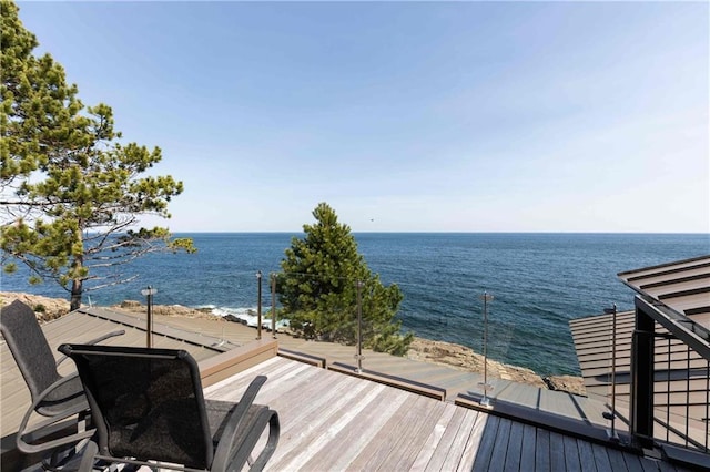 wooden terrace featuring a water view