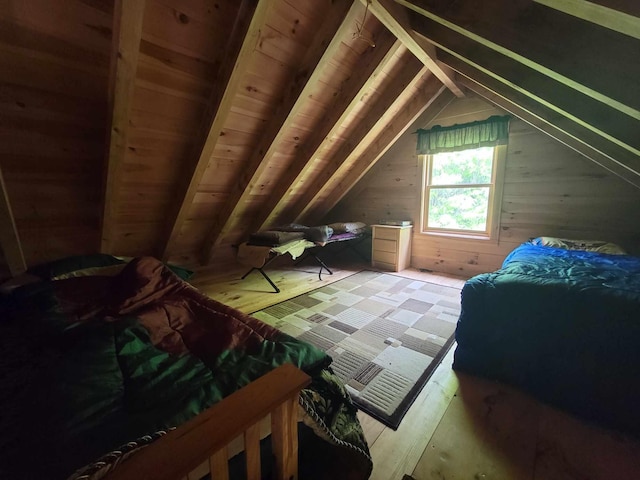 bedroom featuring vaulted ceiling, wooden walls, and wooden ceiling