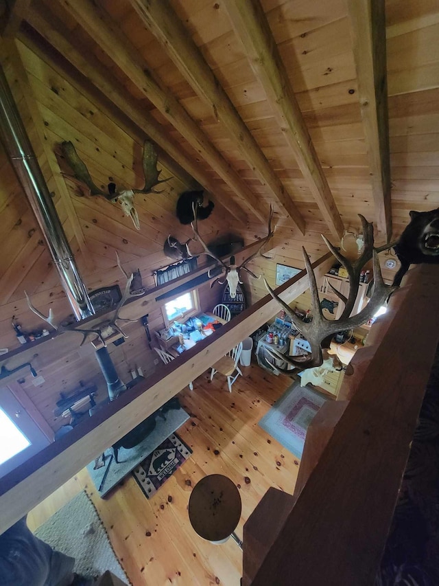 interior space featuring wooden ceiling, wood-type flooring, and beamed ceiling