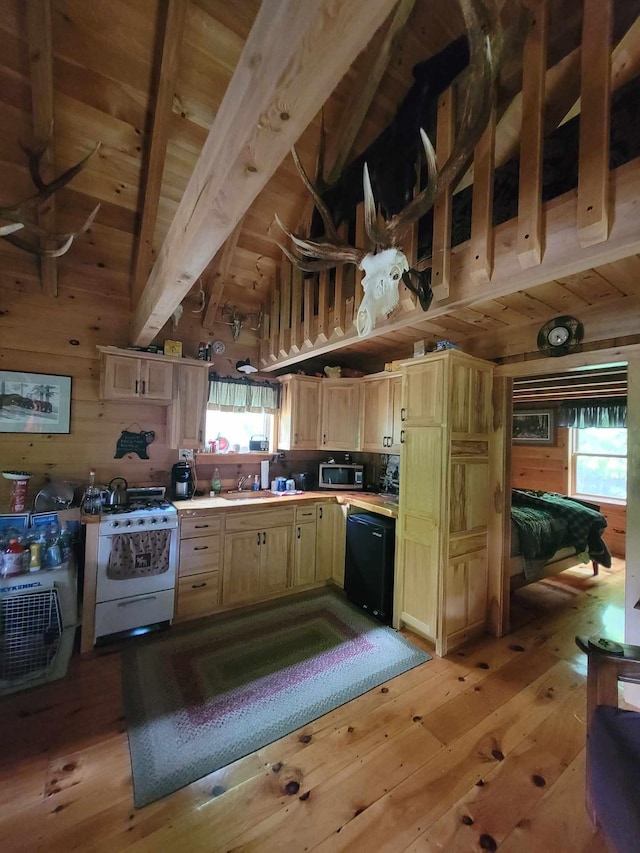 kitchen with dishwasher, white range with gas cooktop, beamed ceiling, light hardwood / wood-style floors, and high vaulted ceiling