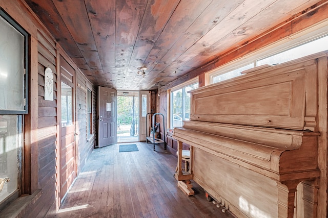 misc room with wooden walls, dark hardwood / wood-style flooring, and wood ceiling