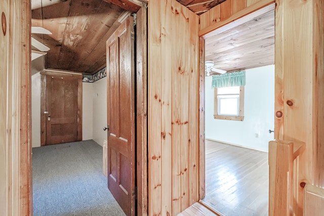 hall featuring wood walls, hardwood / wood-style floors, and wood ceiling