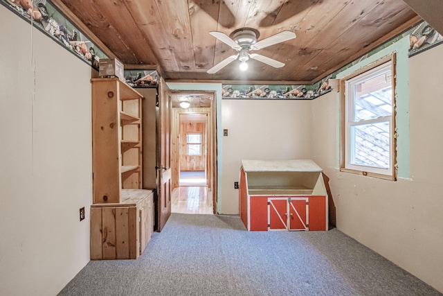 interior space featuring carpet floors and wood ceiling